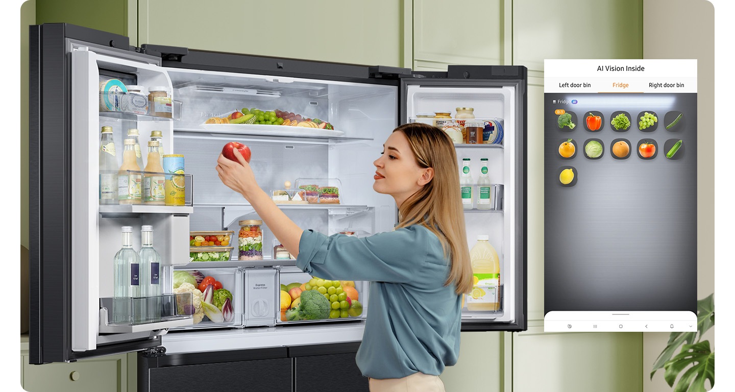 A refrigerator filled with fresh ingredients. As the woman adds an apple to the fridge, AI Vision Inside detects the new inventory. She notices broccoli that's about to expire and takes it out of the fridge. AI Vision Inside tracks that the broccoli has been removed.