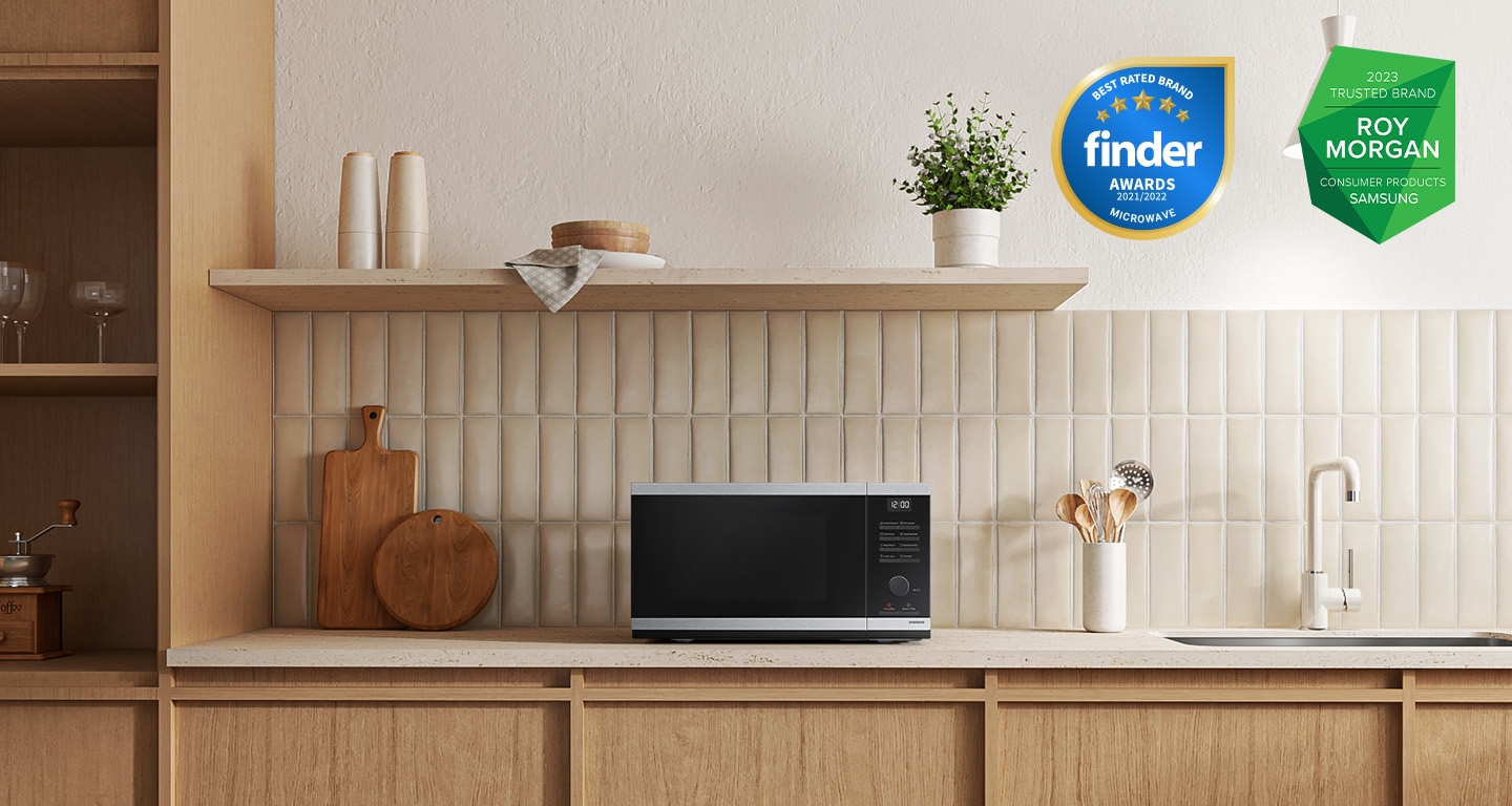 Shows the microwave oven on the counter top of a modern kitchen.