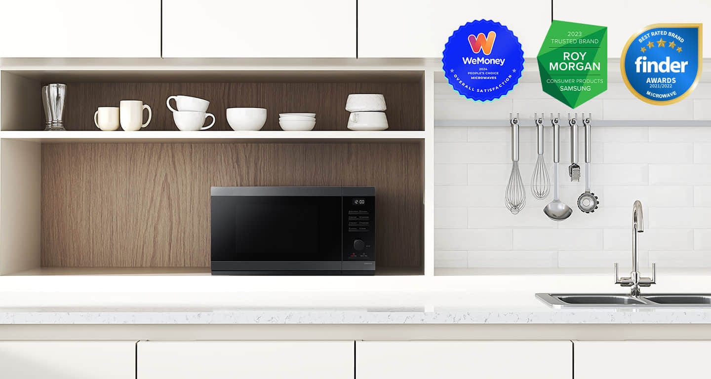 Shows the microwave oven on the counter top of a modern kitchen.