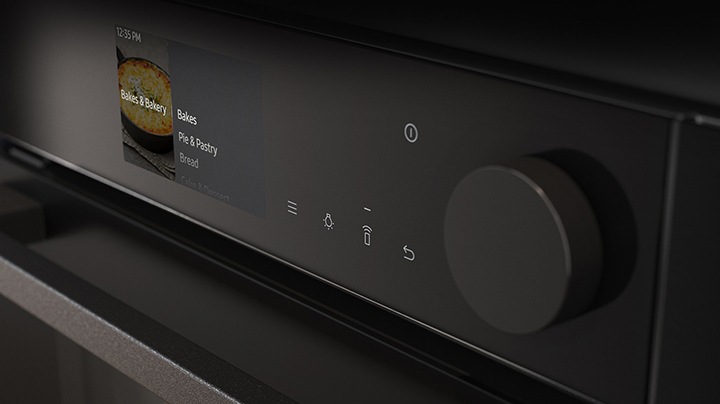 Shows a close-up of the oven's stylishly minimalist control panel with an LCD display, touch control and a single knob.