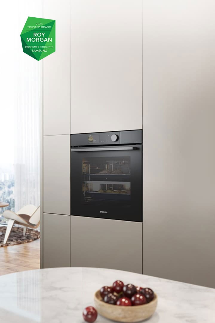 Shows the built-in oven installed in a kitchen, with two cooking zones and a hinged door, next to a Microwave Combi oven.