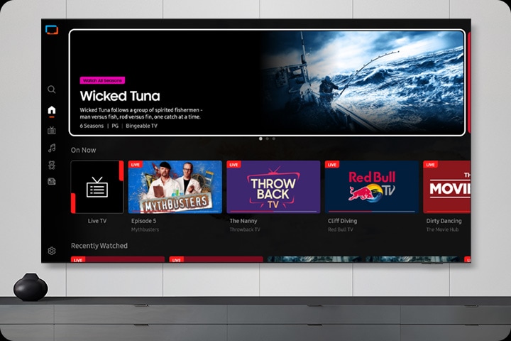 TV in a living room shows Samsung TV Plus home screen and the diverse TV channels available with it.