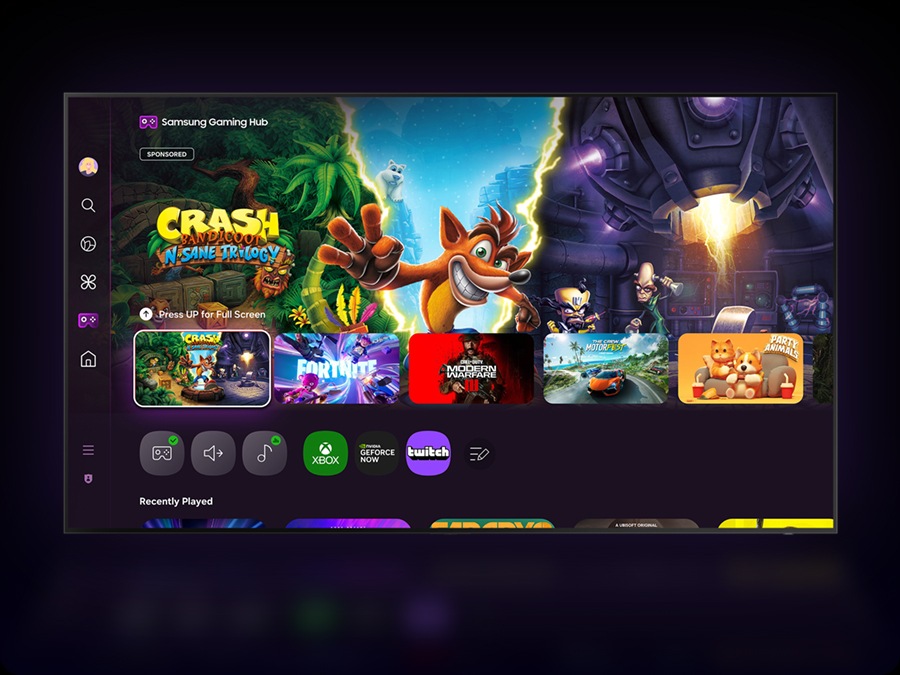 A TV displays the Samsung Gaming Hub home screen, which has options for streaming and playing games.