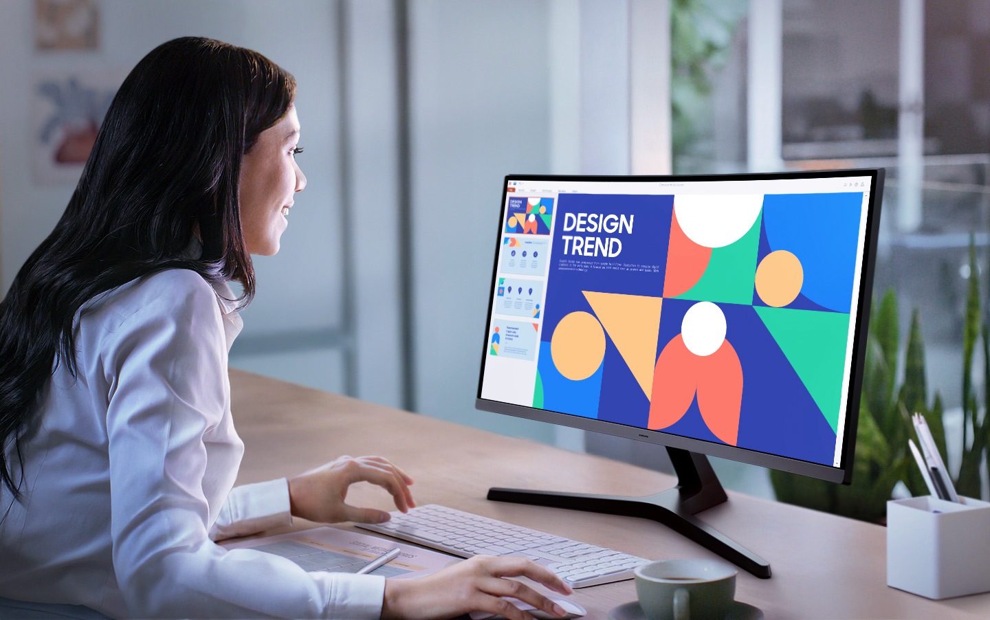 A woman is working on a document with the Essential Monitor S3.