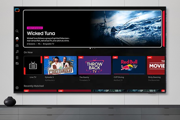 TV in a living room shows Samsung TV Plus home screen and the diverse TV channels available with it.