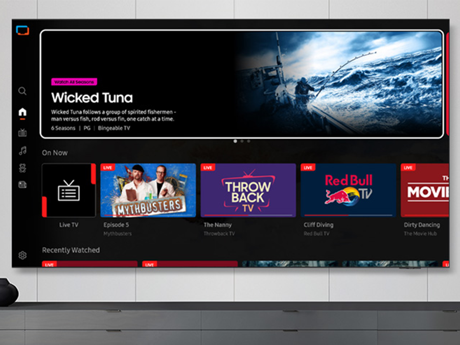 TV in a living room shows Samsung TV Plus home screen and the diverse TV channels available with it. 