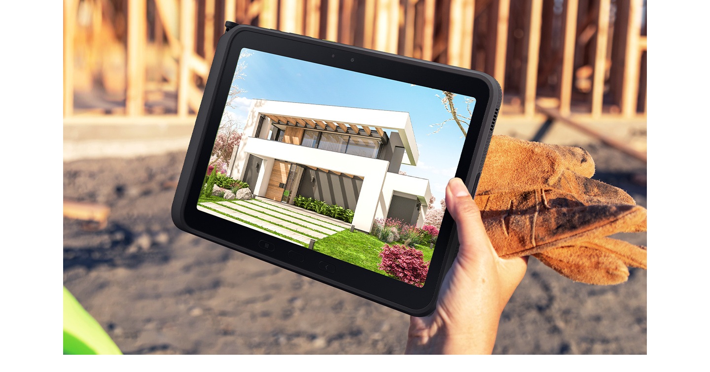 A hand holds Galaxy Tab Active5 Pro at a construction site, with a detailed house rendering visible onscreen — demonstrating display clarity in outdoor conditions.