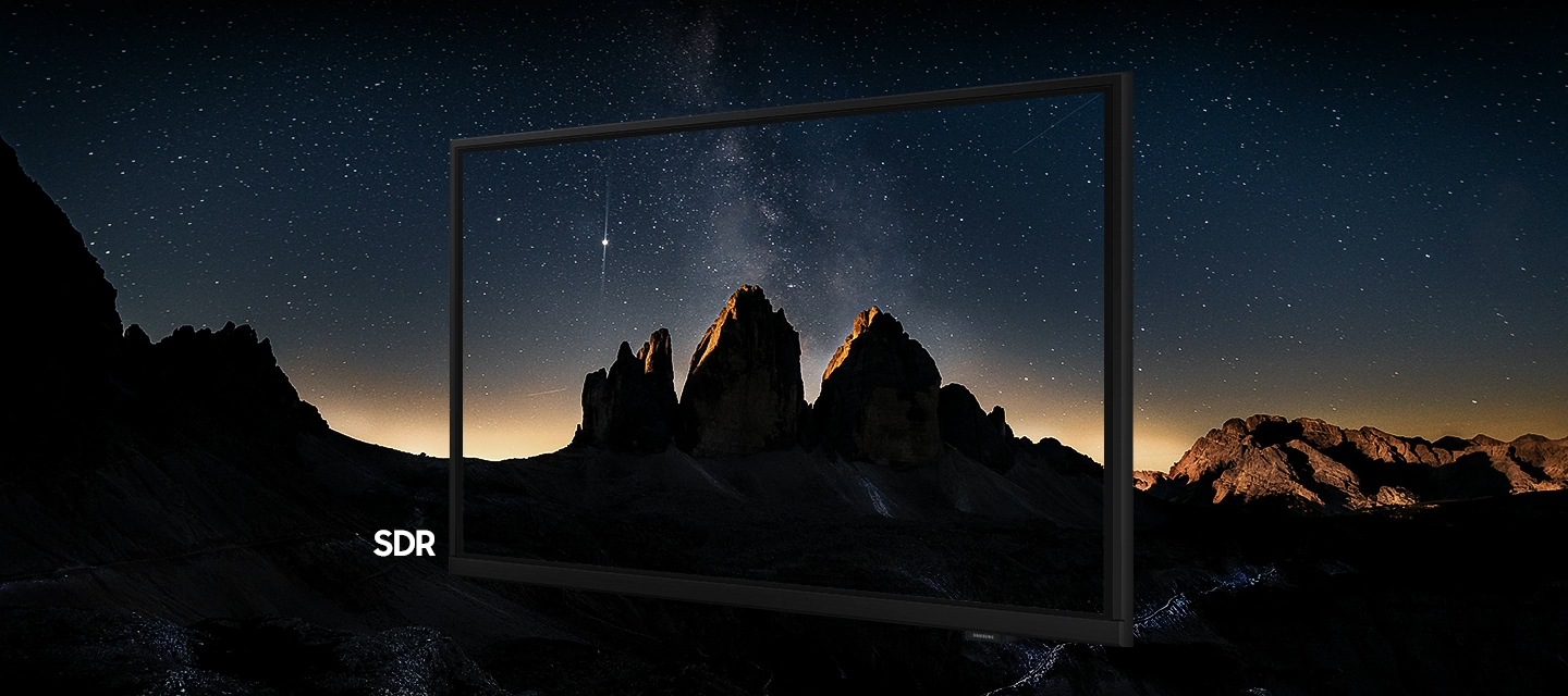 A screen shows a mountainous landscape against the night sky in SDR. The image is dark and details are not visible. As the image is transformed into HDR, it becomes brighter with more contrast, revealing hidden details and bringing the landscape to life.
