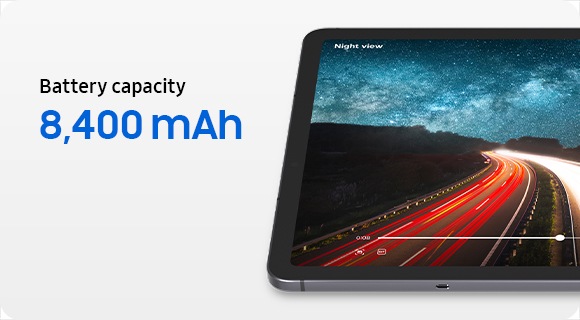 A part of Galaxy Tab S11 screen showing a high-speed video of a subject on a road, with text reading Battery capacity 8,400 mAh and Watch videos up to 18 hours, to emphasize long-battery life for extended use throughout the day.