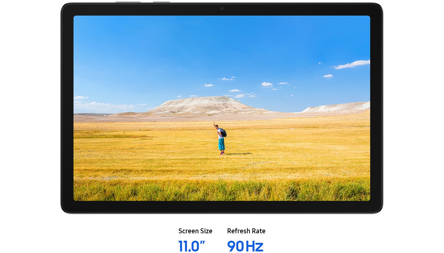 Galaxy Tab A11+ is placed horizontally, displaying a clear image of a man waving his hands, suggesting a free-spirited mood. In the background, a blue sky stretches over a wide horizon of yellow and brown grass. Text reads Screen Size 11.0-inch, Refresh Rate 90 Hz.