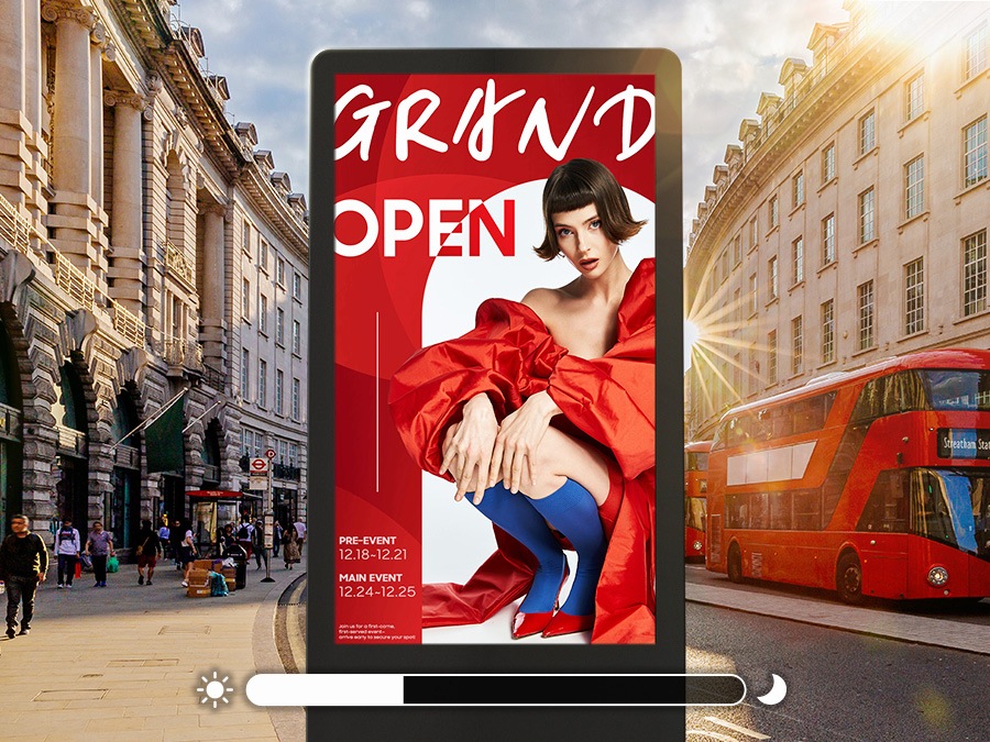 An outdoor digital advertisement featuring a fashion-themed grand opening announcement. The display has a bold with the text 'GRAND OPEN'. A model dressed in an avant-garde outfit; with a red garment, blue stockings, and red shoes, is prominently featured. The event dates and details are listed in