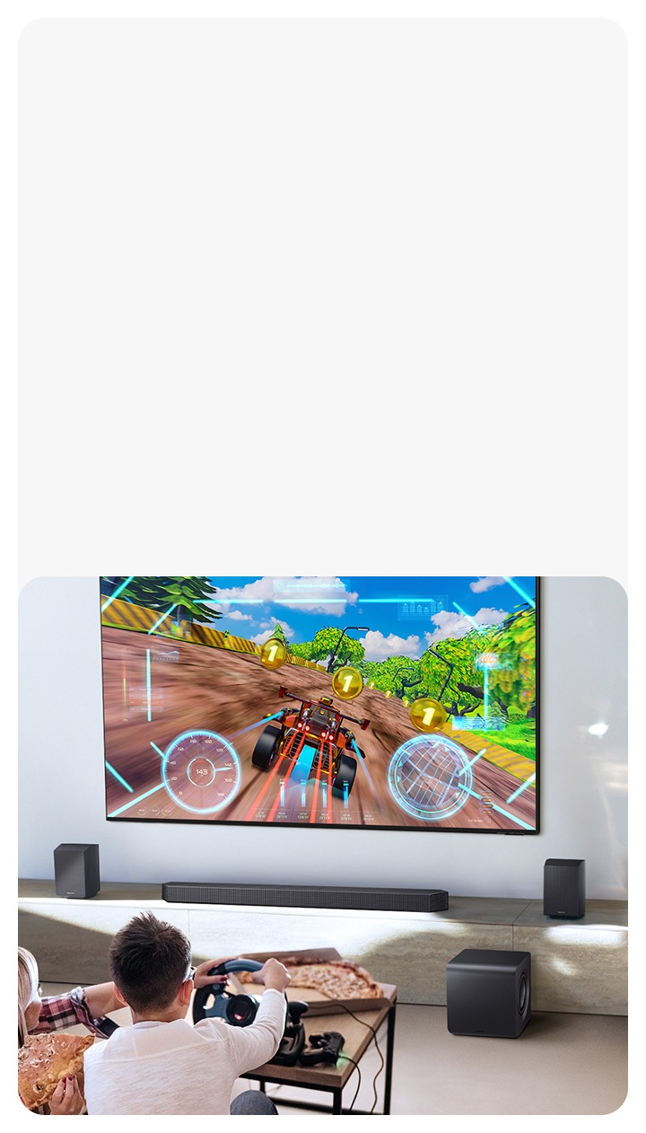 Two people enjoy an immersive 3D-like gaming experience with Game Pro mode on their Samsung soundbar.