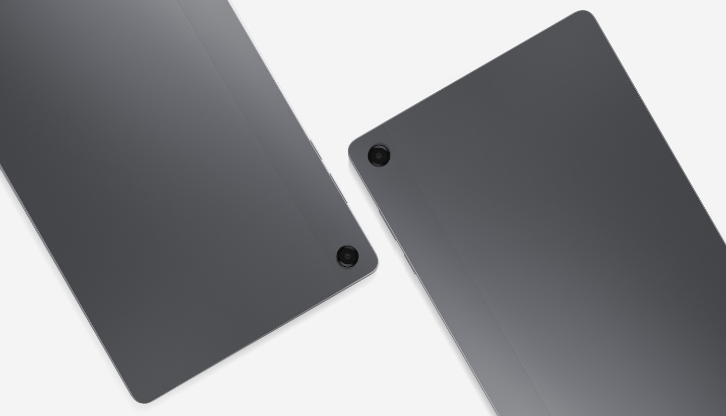 Two Galaxy Tab A11+ tablets are placed side by side, with their backs facing the viewer. The back camera lenses of both tablets are visible.