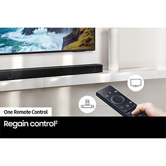 A user controls both soundbar and TV functions with Samsung TV remote.
