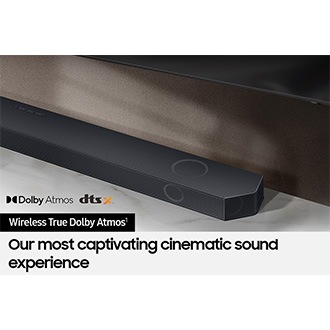 Samsung Soundbar connected wirelessly to TV. Dolby Atmos logo and dts x logo.