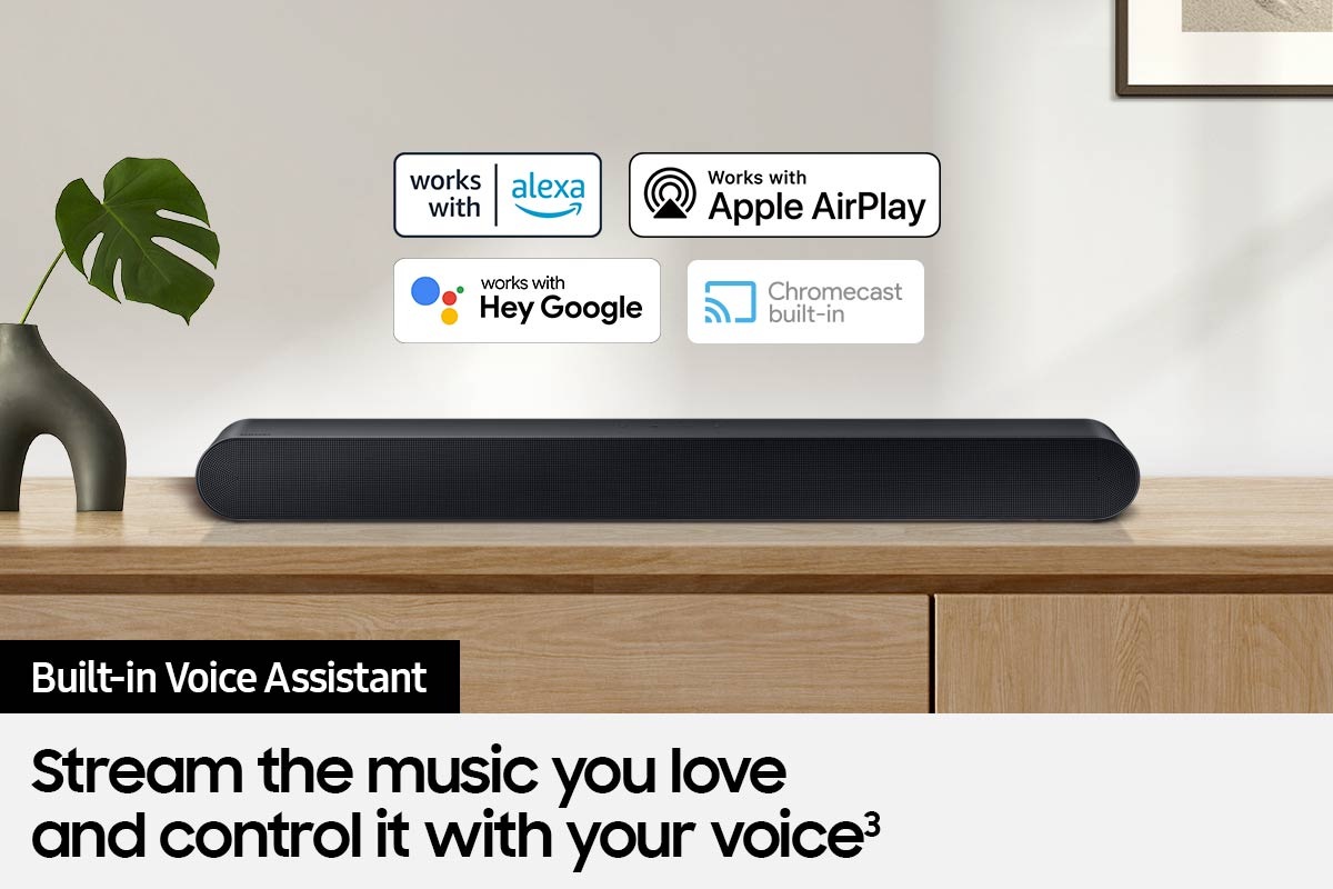 Alexa logo, Apple AirPlay logo, Hey Google logo, and Chromecast Built-in logo can be seen along with Samsung S60B soundbar which is sitting on living room cabinet.