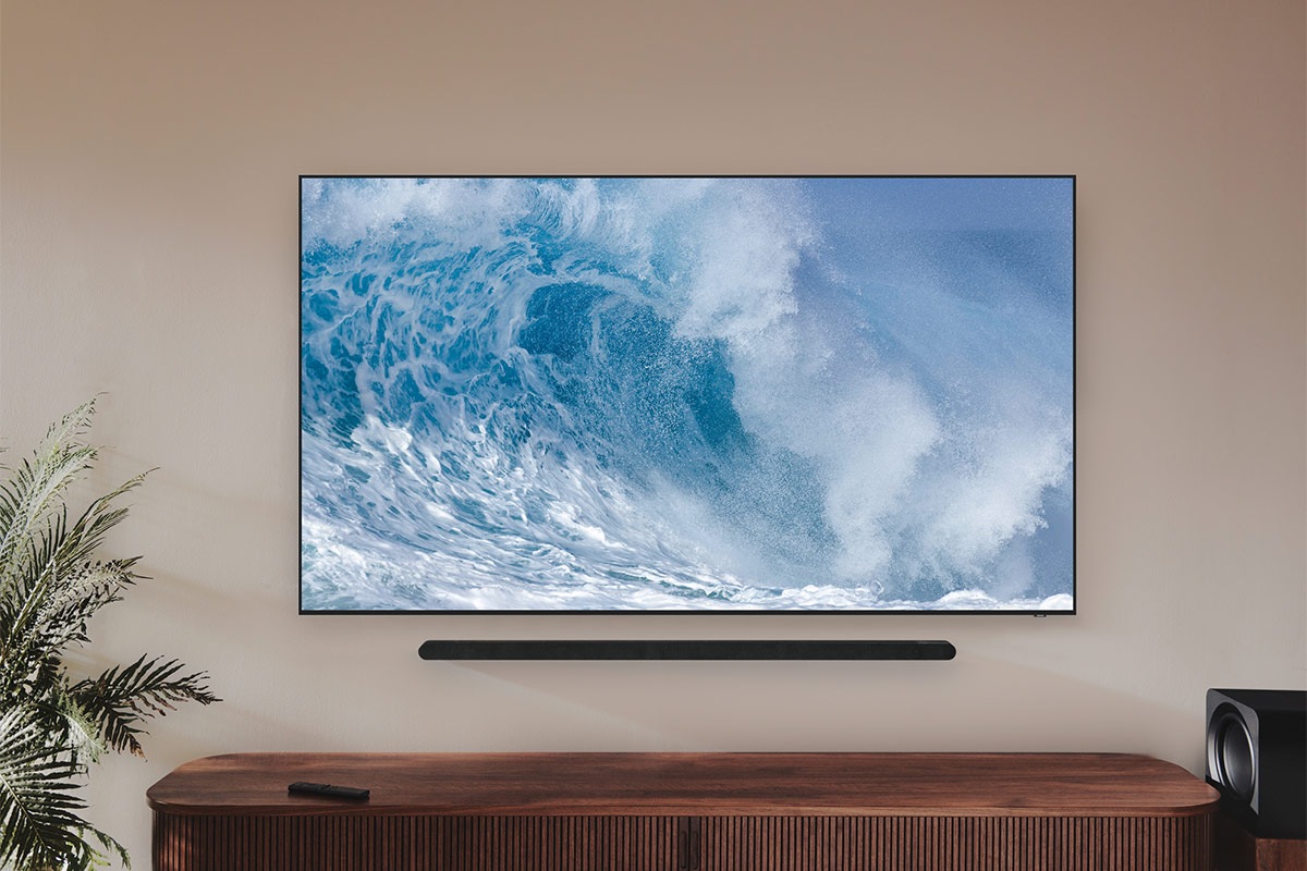 Samsung Ultra slim soundbar, subwoofer and a TV in a living room.  *Cable not shown.