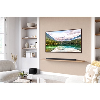 A Samsung TV on the wall and Samsung Soundbar S800D on a shelf underneath, with a subwoofer to the side.