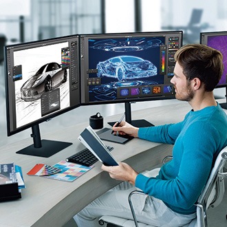 [Máñ s~íttí~ñg át~ désk~ íñ bl~úé sh~írt w~íth t~hréé~ Sáms~úñg V~íéwF~íñít~ý scr~ééñs~ óñ á d~ésk]