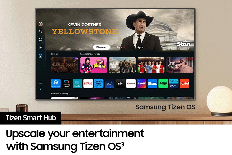 A wall-mounted TV shows popular apps and curated content on the "Samsung Tizen Smart Hub" home menu.