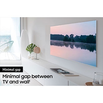 A TV is hanging on the wall via an articulating TV mount.