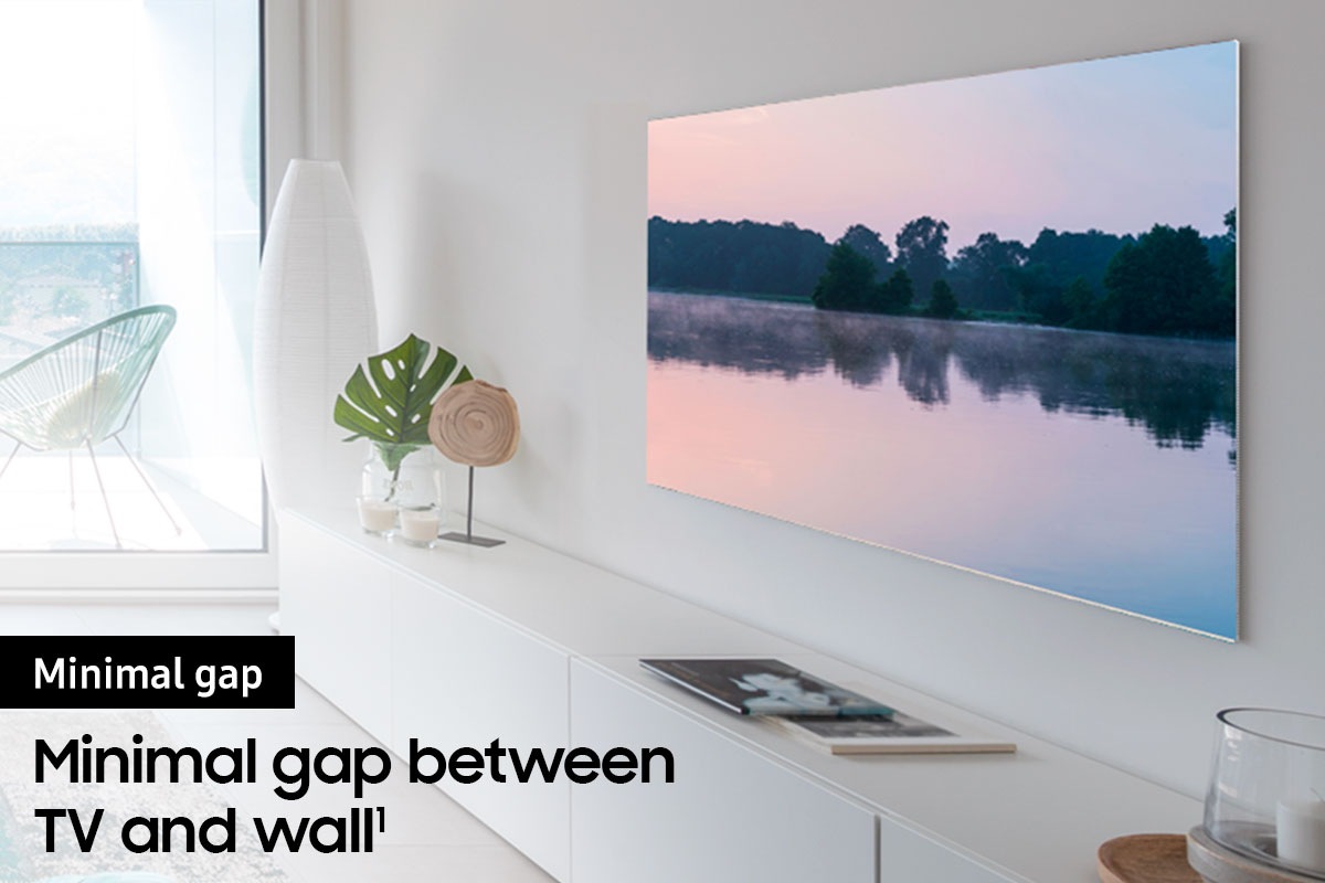 A TV is hanging on the wall via an articulating TV mount.