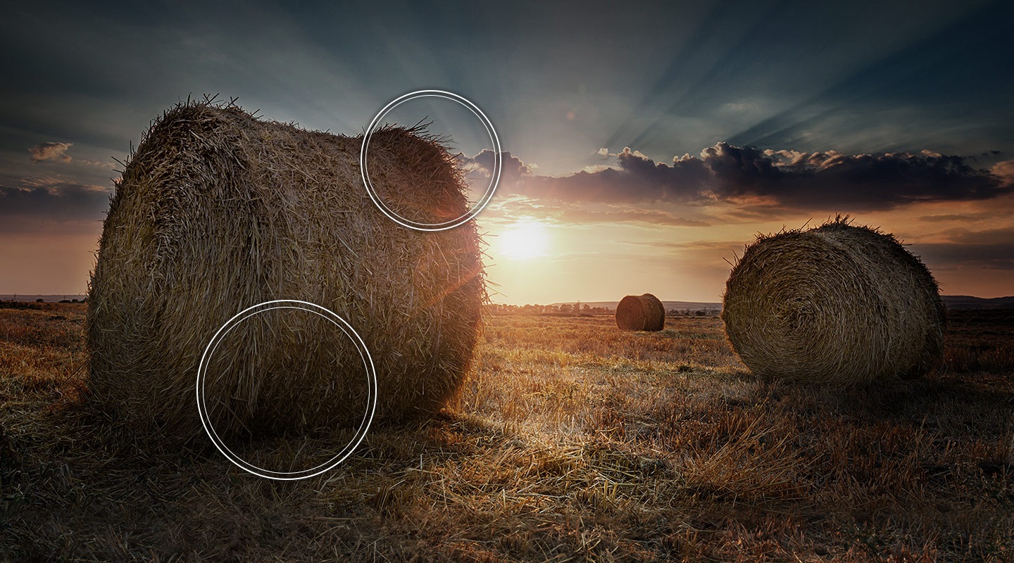 The sun is setting over a prairie showing suboptimal contrast without Quantum HDR technology.