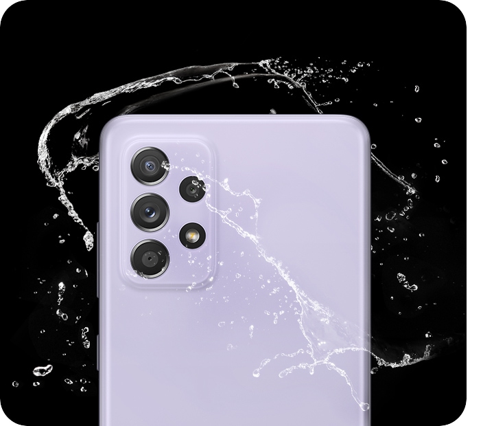 Galaxy A52s 5G in Awesome Violet, seen from the rear with water splashing around it.