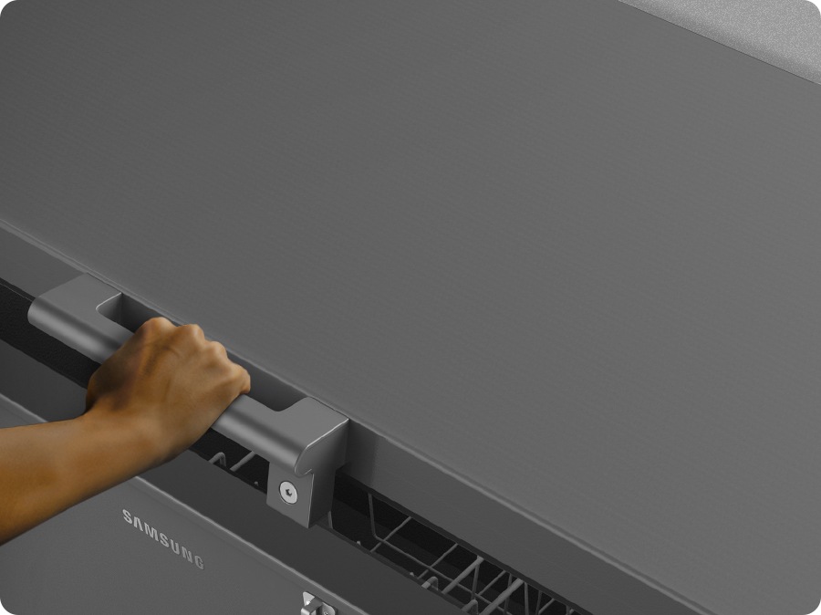 A person is holding the refrigerator’s bar handle and opening the door.