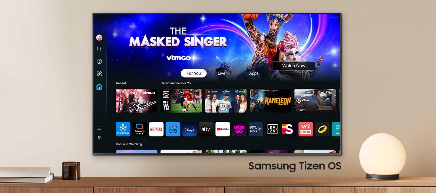 A wall-mounted TV shows popular apps and curated content on the home menu. "Samsung Tizen OS"