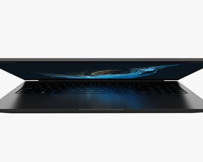 A slightly open graphite-colored Galaxy Book2 is facing forward with a wallpaper of blue waves.