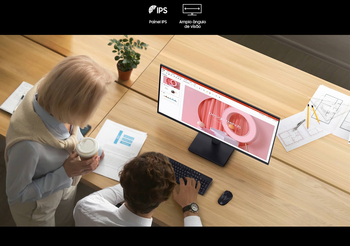 There are two people looking at a document on the Essential Monitor S3. And there are IPS and Wide Viewing Angle icons above them.