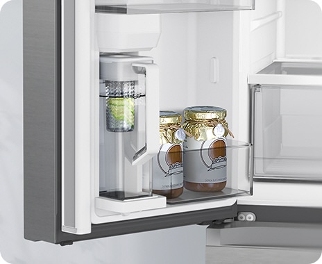 The fridge door is open to show the Autofill Water Pitcher filling with water, and with lemons in the built-in infuser.