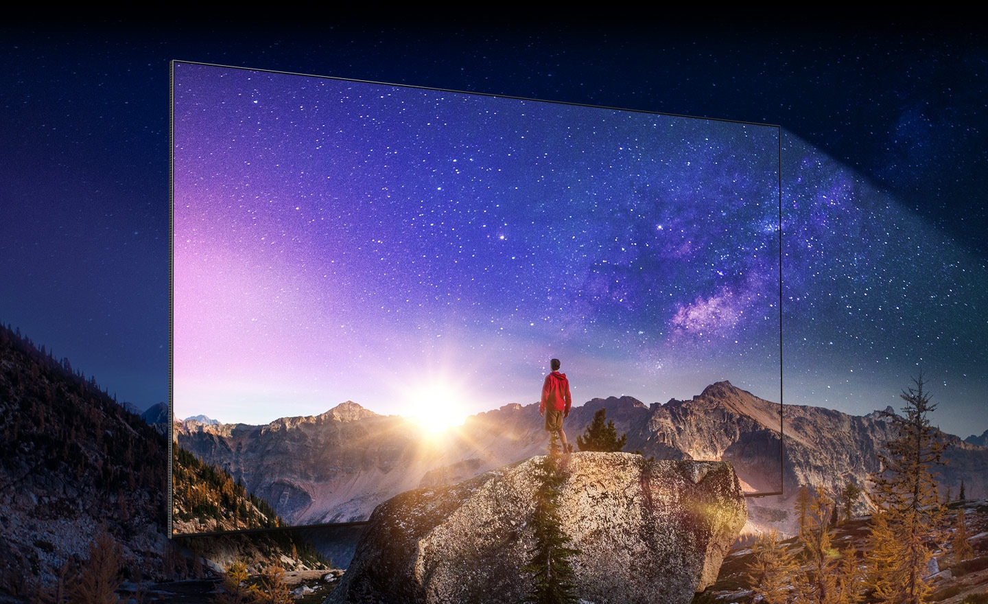 A man is on top of a mountain looking at a magnificent view. QLED's nearly bezel-less frame appears to show the stellar picture and clear contrast.