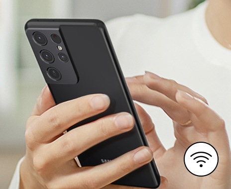 A person is managing refrigerator remotely via smartphone and wi-fi.