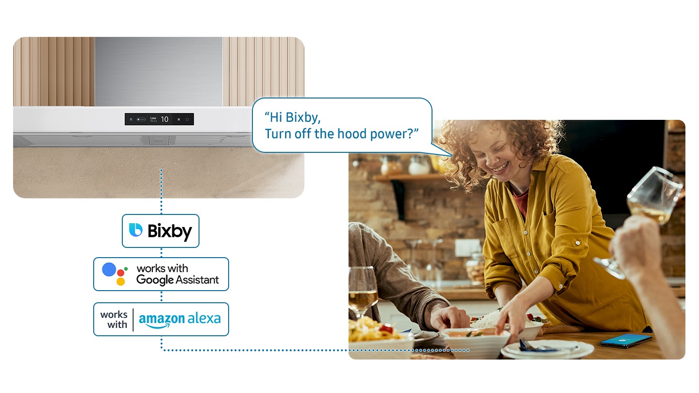 Shows a woman serving food to a table while controlling NK8000 with her voice using a voice assistant on smartphone, such as Samsung Bixby, Amazon Alexa or Google Assistant. She says, “Hi Bixby, Turn off the hood power?”