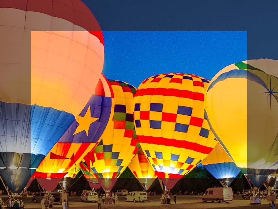 Colorful hot air balloons are on display. The center side is more colorful and has depth compared to the edges.