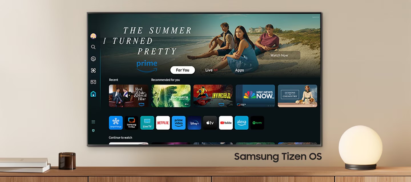 A wall-mounted TV shows popular apps and curated content on the home menu. "Samsung Tizen OS"
