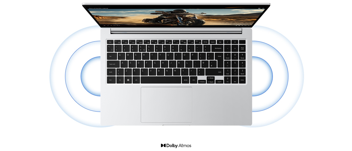 Top view of Galaxy Book4 in Silver, open and facing forward with a YouTube video playing in full screen and sound waves coming out of the dual stereo speakers. Dolby Atmos logo is shown.