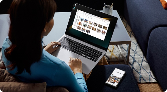 A person is using Galaxy Book4 Pro and Galaxy S24 Ultra to copy and paste images between the devices using Multi Control.