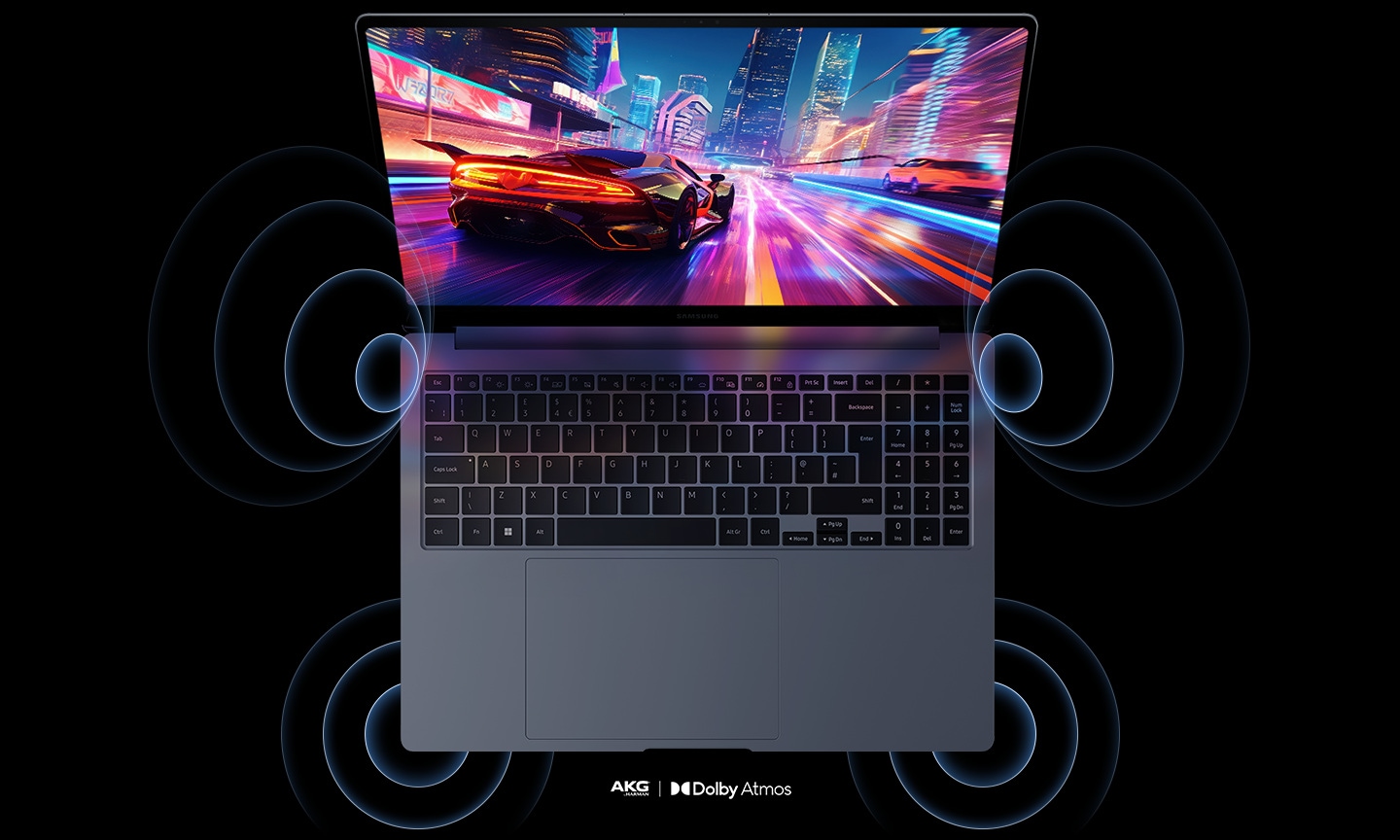 Top view of Galaxy Book4 Ultra, open and facing forward with a racing game shown onscreen and sound waves coming out of the four speakers. AKG by Harman and Dolby Atmos logos are shown.