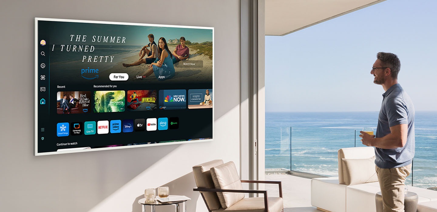 A man is looking at various entertainment options offered on Samsung Tizen OS on The Frame TV.