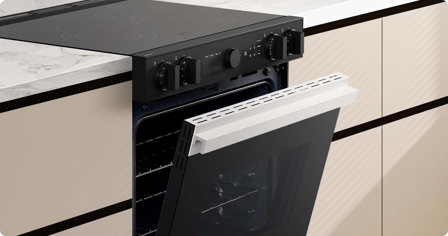 The oven door is slightly open. The oven has a flat door and a recessed type handle. The design is sleek and seamless.
