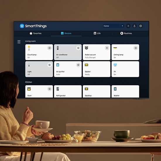 The TV displays SmartThings with various 