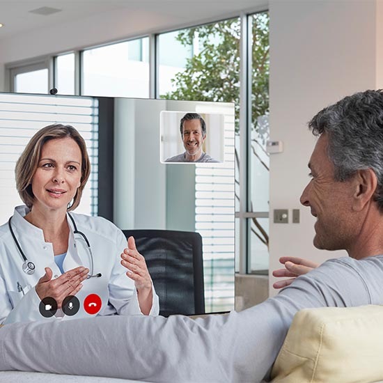 A man is having a consultation with doctor remotely via his TV at home.