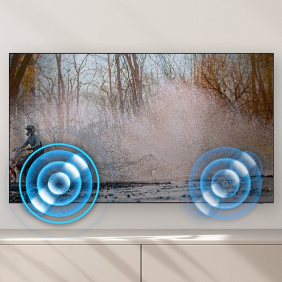A person on a motorcycle is zipping past from one side to another. Built-in speakers follow the sound of the motorcycle as it moves.