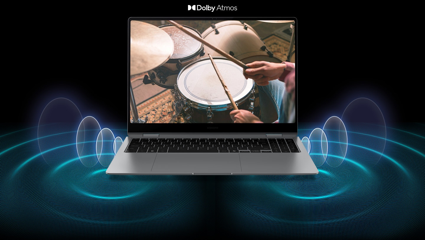 Galaxy Book5 Pro 360 is open, facing forward with a person playing the drums shown onscreen and sound waves coming from the big woofers and the quad-speaker system. Dolby Atmos logo.