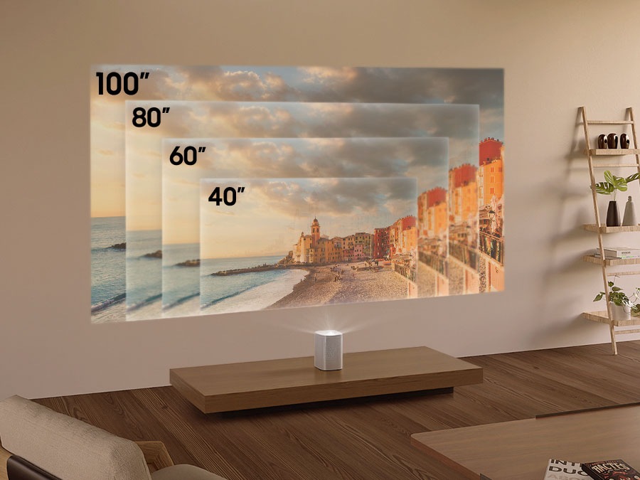 The Premiere is placed 11.7 cm away from the wall where it projects an image of a beach town. As The Premiere is moved away from the wall, the screen grows in size to 40 inches, 60 inches and 80 inches. When The Premiere is 43.3 cm away from the wall, it shows the maximum screen size of 100 inches. 