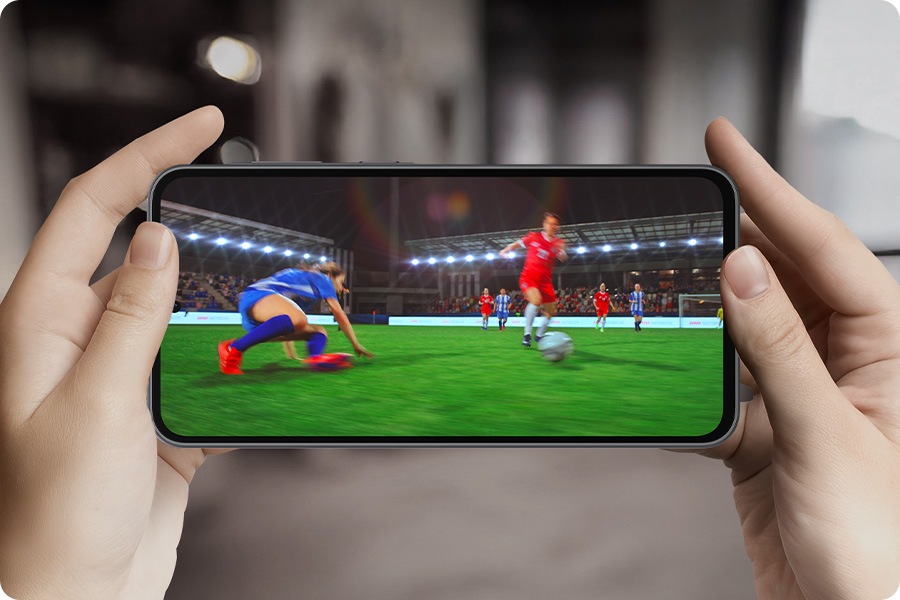 Text Octa Core can be seen. The screen zooms out showing the Octa Core text onscreen with a person holding Galaxy A36 5G horizontally. The screen then switches to a video of a soccer match.