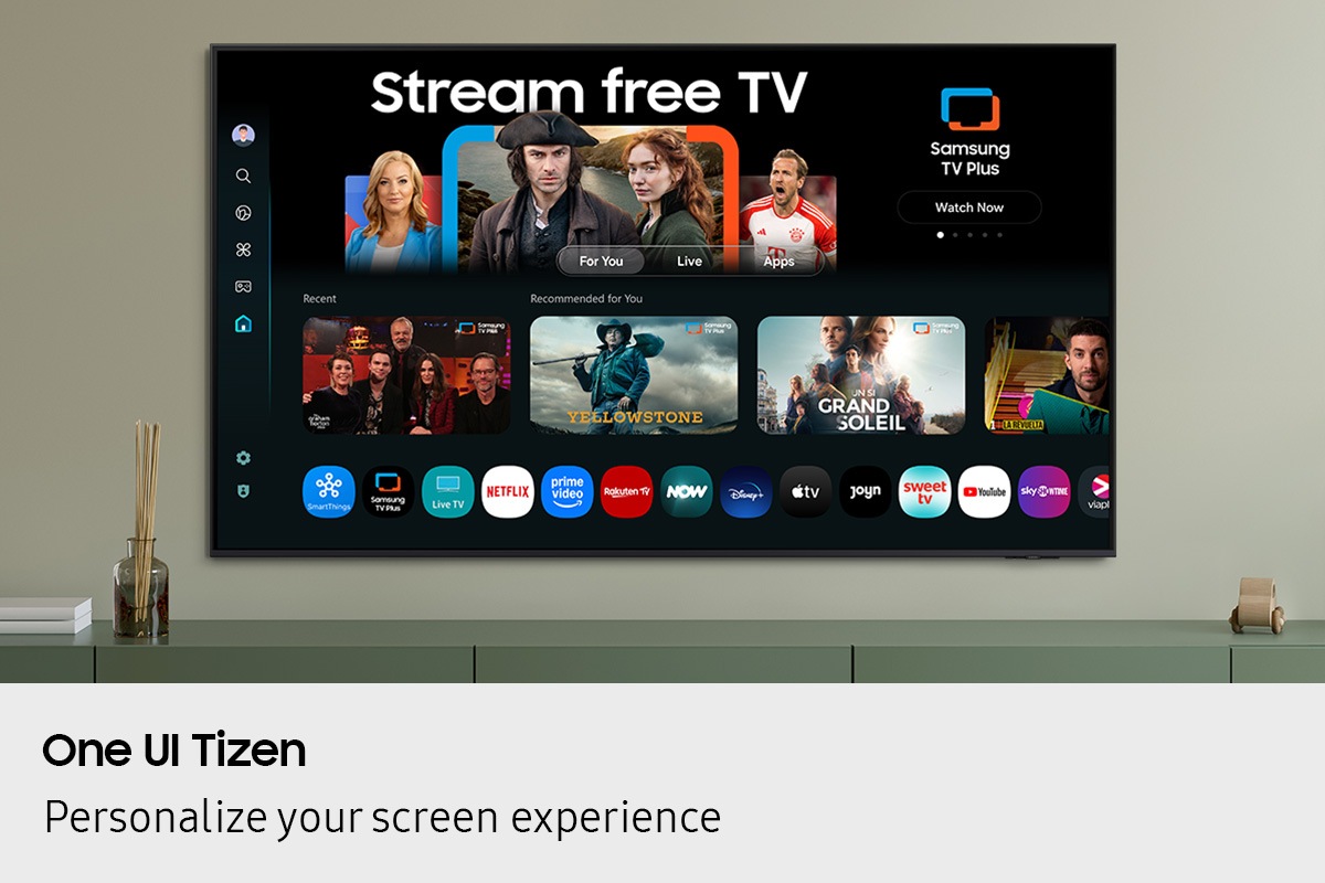 One UI Tizen’s home screen, with the various apps and services available, is displayed on a TV in a living room.